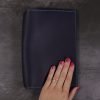 A5 navy and teal leather notebook closed hand 2