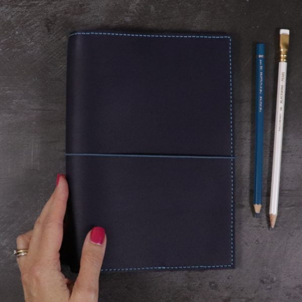 A5 navy and teal leather notebook closed insitu