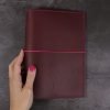 A5 red and fuchsia leather notebook closed elastic hand