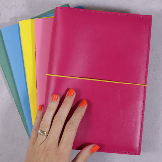 fuchsia pink leather journal with coloured notebooks 1