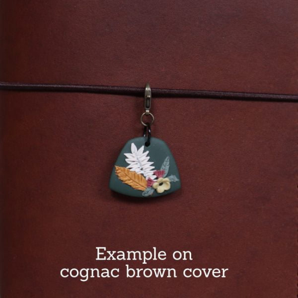 nature journal charm - green - example on cognac close