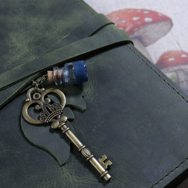 Secret Garden leather journal cover in green - close up key and potion